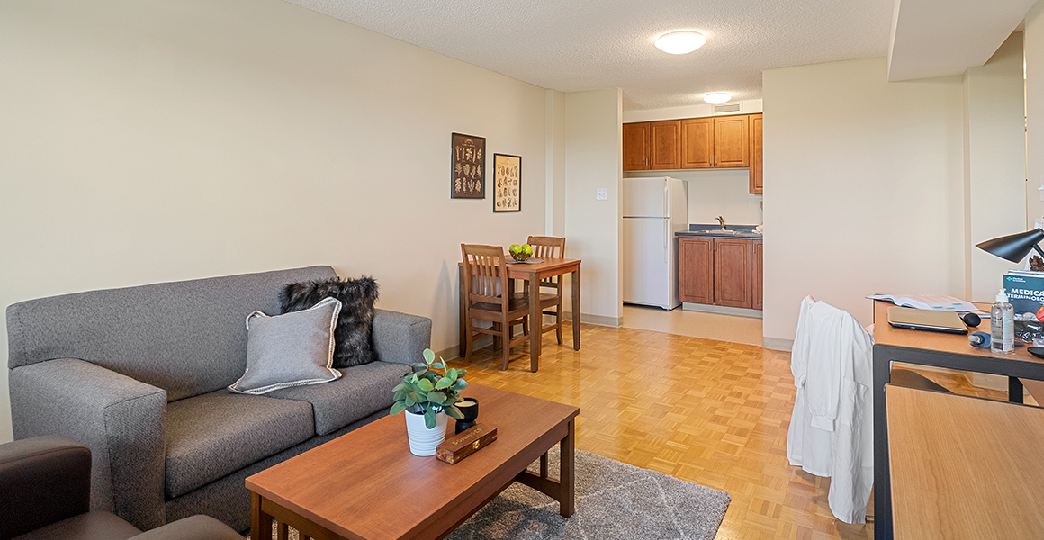 Living room showing couch, coffee table and dining table