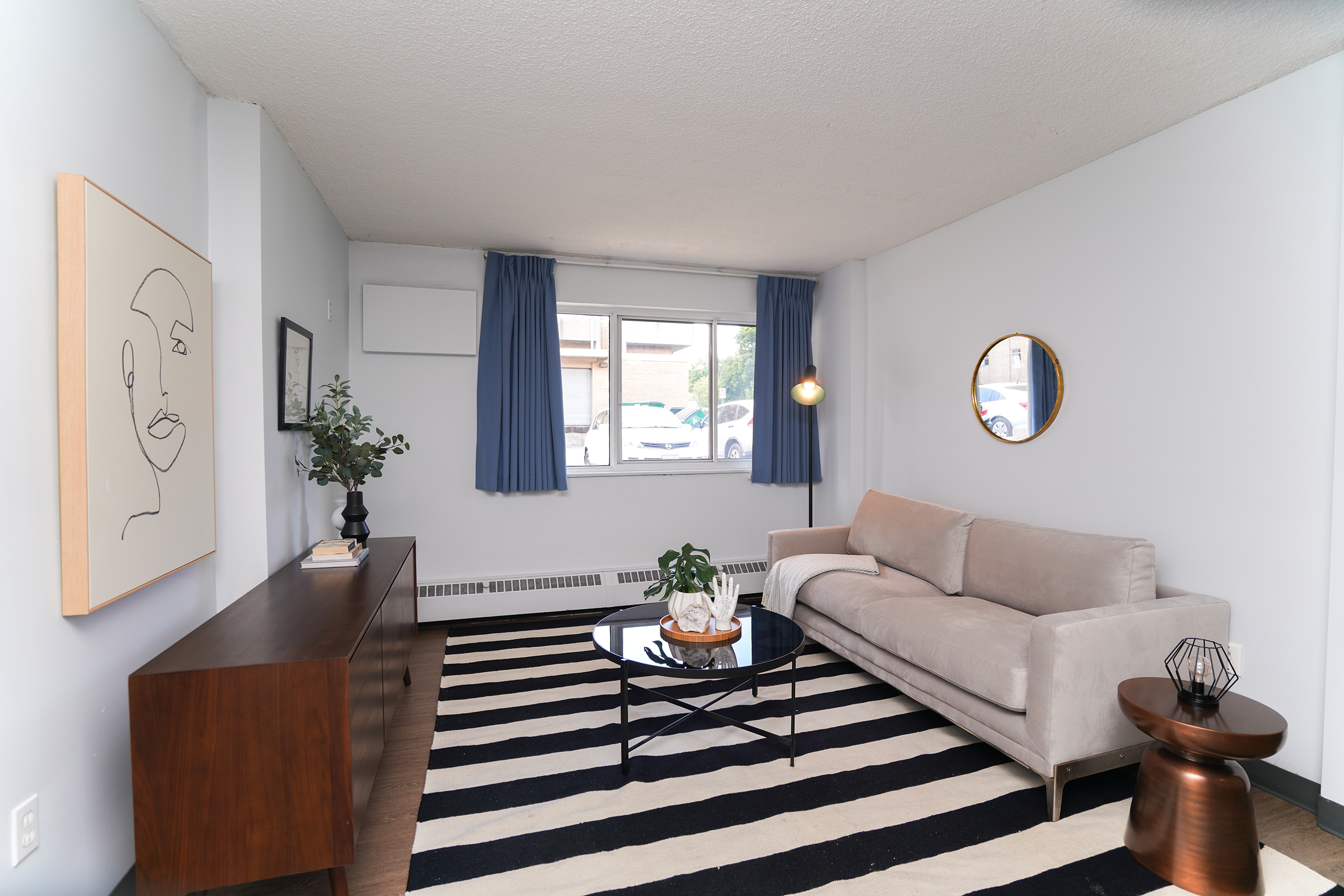 Living room showing couch, coffee table and TV stand
