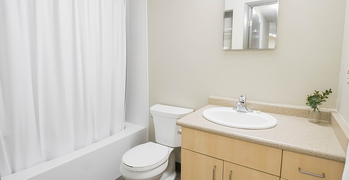 Bathroom showing shower, toilet and sink