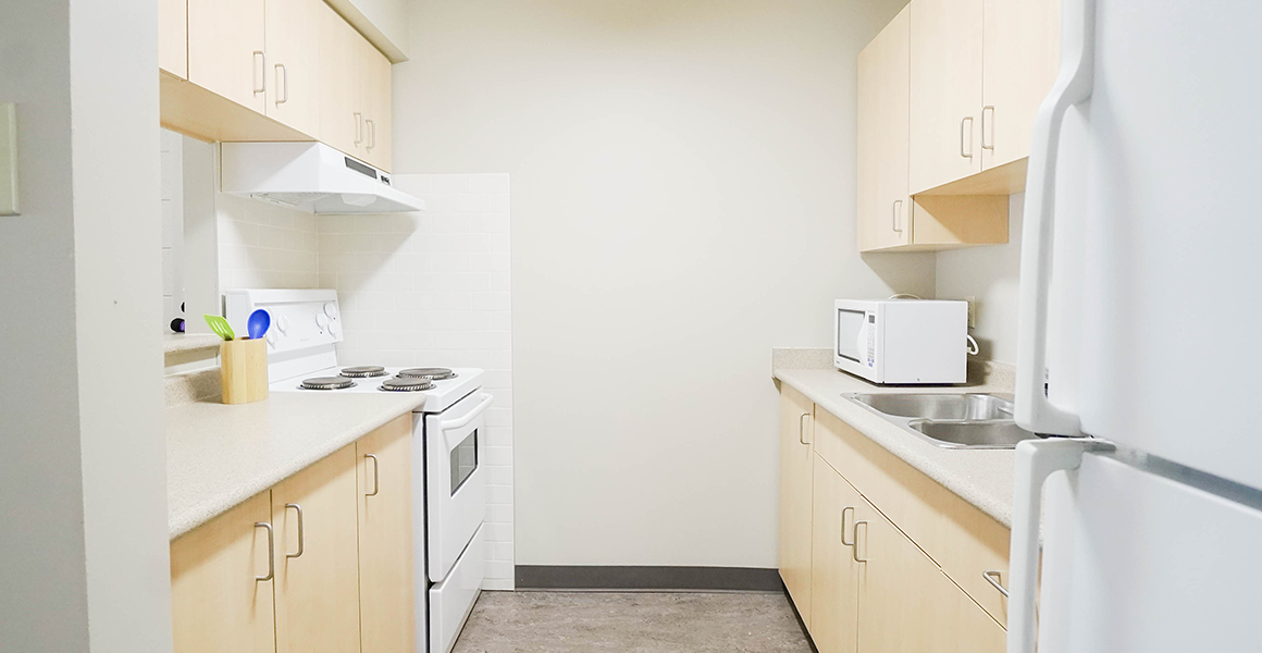 Kitchen showing oven, sink, fridge and toaster