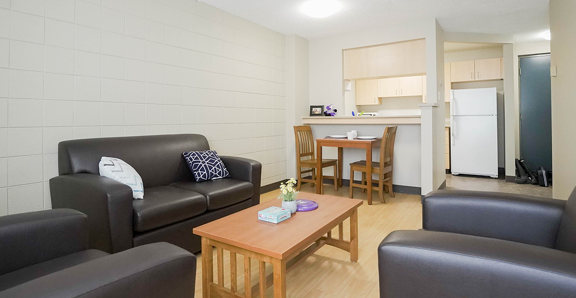 Living room showing love seat, two chairs and dining table