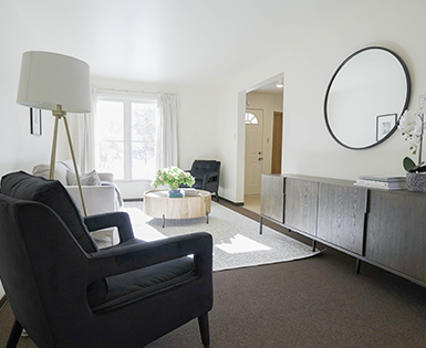 Living room showing cabinet, chair, couch and decor