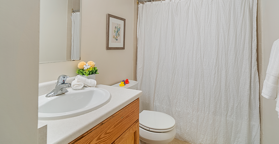 Bathroom showing shower, sink and toilet
