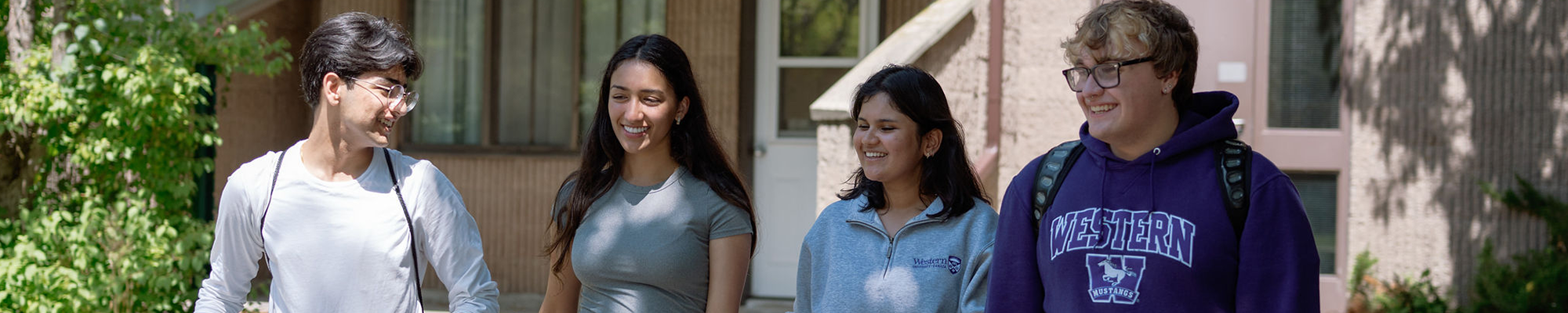 Four students walking out their building