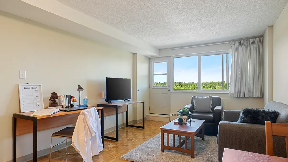 Living room showing couch, chair and TV stand