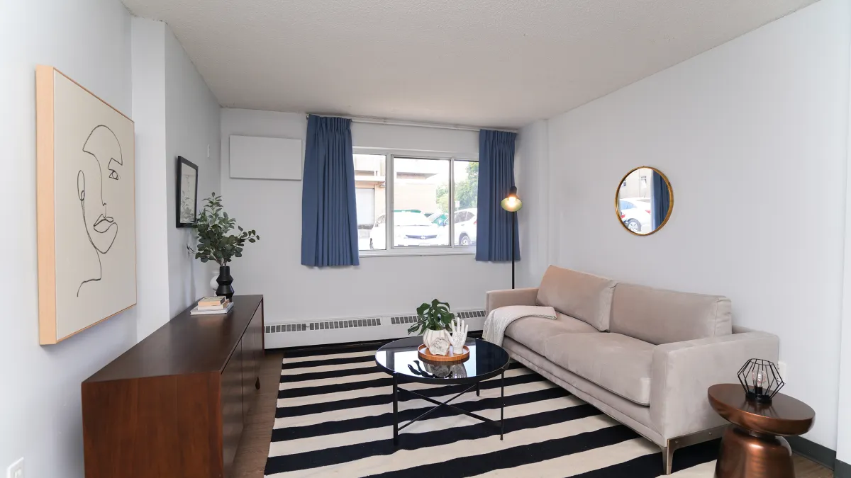 Living room showing couch, coffee table and TV stand