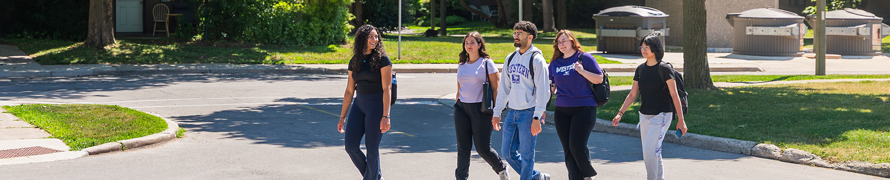 Group of students walking through neighbourhood