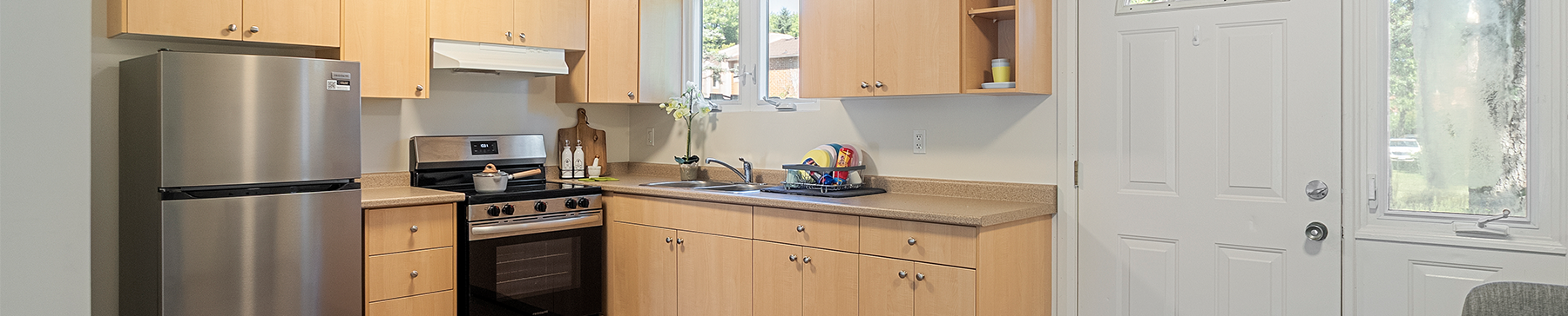 Kitchen showing fridge, oven, sink and dining table